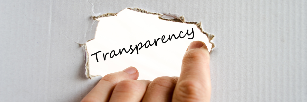 fingers holding label that says transparency with burnt edges on white background